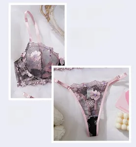 Detailed embroidery of pink floral lace on black mesh lingerie with satin straps