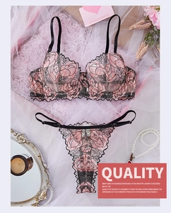 Close-up of pink floral embroidery and black mesh fabric on sexy lingerie set