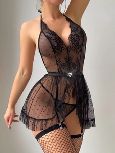 Close-up of black lace lingerie set with heart buckle belt and fishnet stocking clips