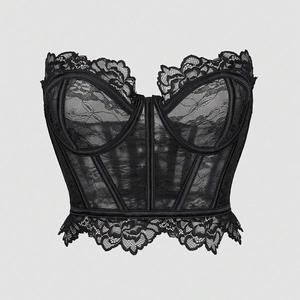 Close-up of black floral lace corset top with sheer fishbone structure and scalloped edges