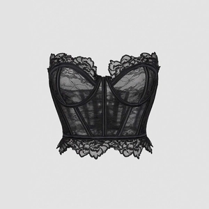 Detail of black floral lace corset featuring structured boning and scalloped edges