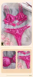 Detailed close-up of pink floral lace lingerie set with heart-shaped metal buckle detail