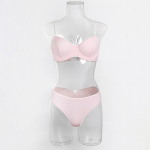 Detailed view of pink ribbed lingerie set featuring white lace trim and underwired bra