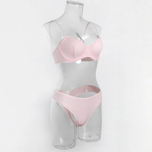 Detail view of pink ribbed lingerie set with white lace trim and clear straps on mannequin