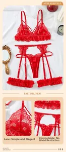 Detail view of red floral lace lingerie set with garter belt and matching leg rings