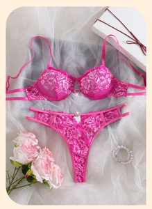 Detail view of rose pink lace lingerie set with heart rhinestone and flower motifs