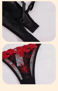 Dettaglio di lingerie in mesh nero con ricamo floreale rosso e spalline regolabili