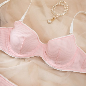 Sexy pink ribbed push-up bra with white lace trim and adjustable straps on mesh