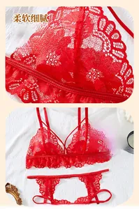 Macro detail of red floral lace lingerie set with non-wired bra on white fabric