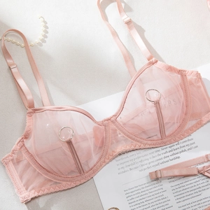 Detail of pink sheer mesh bodysuit featuring metal ring hardware and delicate straps