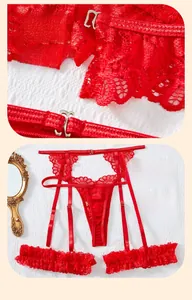 Detail of red lace lingerie set featuring intricate floral embroidery and metallic hooks