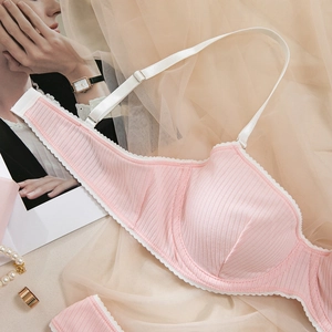 Detail of pink ribbed lingerie set with white lace trim and adjustable silk straps