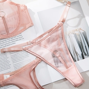 Close-up of pink mesh lace lingerie set with metal rings and satin patchwork detailing