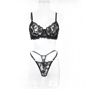 Detailed view of floral lace embroidery and sheer mesh fabric on black underwire bra