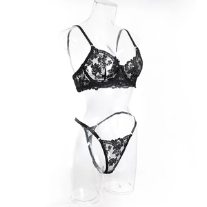 Detailed view of black lace embroidery and sheer mesh fabric on the wired bra set