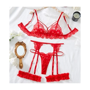 Red floral lace lingerie set with garters and thong on white textured background