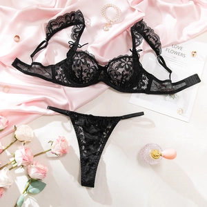 Detailed close-up of a black lace lingerie set with floral straps and eyelash lace edges