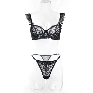 Close-up of black floral lace lingerie set with ruffled straps and fine embroidery