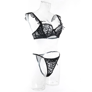 Detail of black floral lace bra with underwire, ruffle straps and delicate bow accents