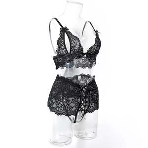 Detail of black floral lace lingerie set with high-waisted ribbon skirt and bow accents