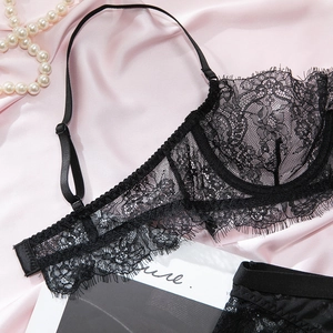 Detailed close-up of black eyelash lace lingerie set with 1/2 cup bra and floral mesh