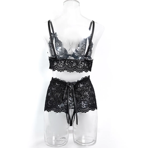 Detail view of black lace lingerie set with floral embroidery and satin ribbon ties