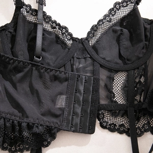 Detailed back view of lace corset with five-row hook and eye closure and mesh