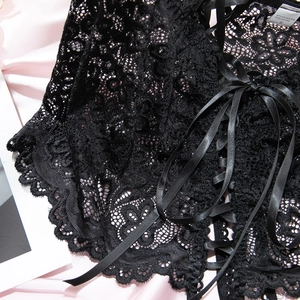 Detail of floral lace texture with satin ribbon crisscross design and size S label