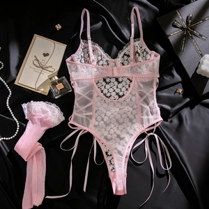Detailed close-up of pink floral lace bodysuit with mesh texture and matching stockings