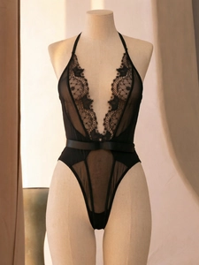 Detail of sexy deep V-neck black mesh bodysuit with intricate floral lace and sheer fabric