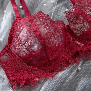 Detail of wine red floral lace bra with delicate eyelash edges and satin straps