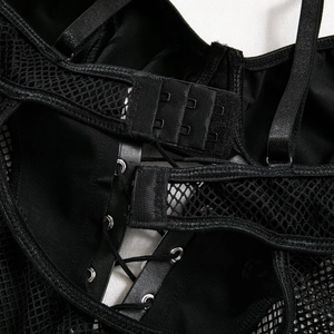 Detail of sheer mesh patchwork and lace-up back closure on sexy black bodysuit