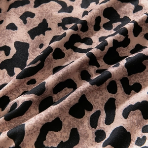 Macro shot of thin leopard print mesh fabric showing soft texture and brown animal pattern