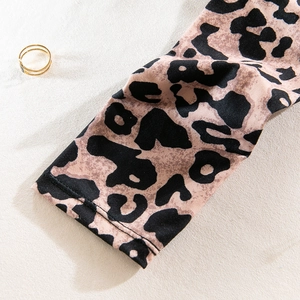 Detail of leopard print sleeve cuff with double-needle stitching and knit texture
