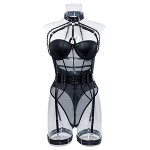 Detailed view of black faux leather and mesh bodysuit with metal rings and garter straps