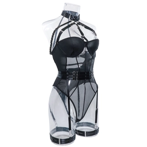 Detail view of black mesh bodysuit with leather harness straps and metallic buckles