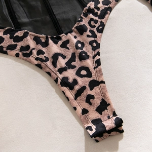 Detail shot of leopard print bodysuit showing mesh panels and structural reinforced seams