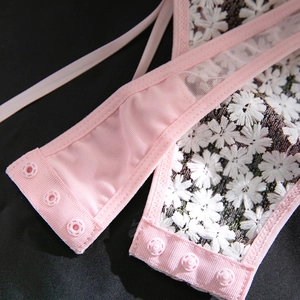 Macro detail of pink daisy lace bodysuit featuring triple row back clasp closure