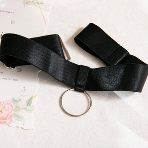 Detail of black mesh bodysuit with silver metal ring and adjustable elastic webbing