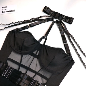 Detail of black harness bodysuit with mesh panels and silver metal buckle adjustments