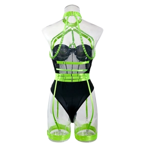 Detail of neon green strappy body harness with silver metal buckles and ring connectors