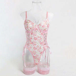 Detail of pink floral lace bodysuit with underwire cups and side ribbon lacing