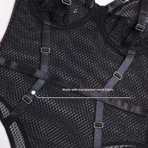 Detail view of transparent fishnet mesh fabric with metal buckles on black bodysuit