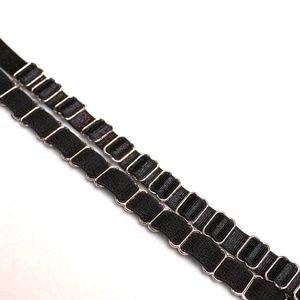 Macro detail of black elastic neck strap with silver metal adjusting buckles and texture