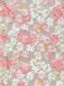 Detailed macro shot of floral embroidery on pink daisy one-piece swimsuit fabric
