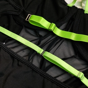 Detail of neon green adjustable strap with metal buckle on mesh patchwork bodysuit