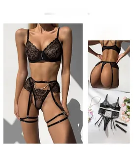 Detailed view of black floral lace bodysuit with double layer metal chains and garter straps