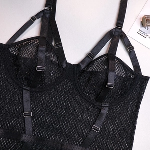 Detail of black mesh bodysuit with adjustable straps and intricate lace texture