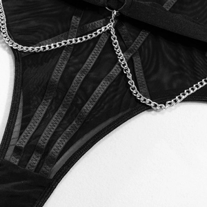 Détail d'un body en tulle noir avec sangles croisées et chaînes en métal argenté