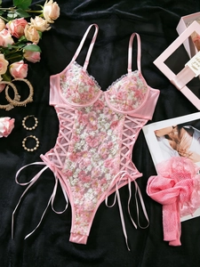 Detail of pink floral embroidery and sheer mesh on sexy one-piece wired lingerie